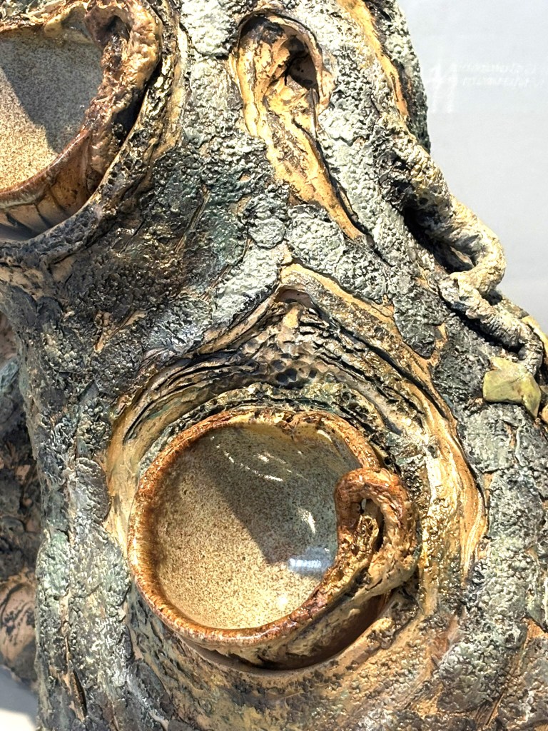 An apparently wooden cup nestled into a stump